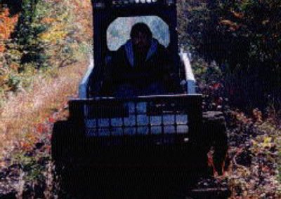 Greg Miller operating a small Bob-Cat for tie removal from Highland Lake to Danbury c. 1999